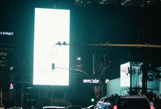 cars-in-traffic-looking-at-bright-neon-bilboard